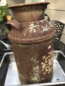 Before Evapo-Rust removed the rust on old milk container